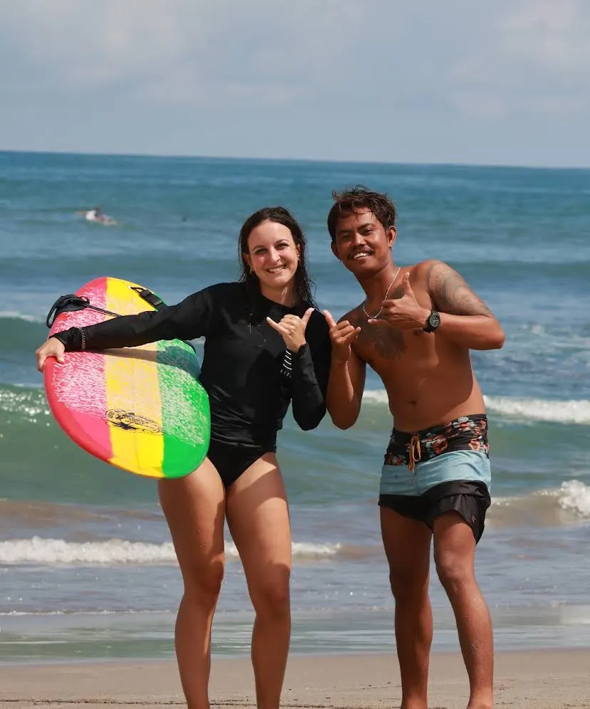 Girl traveler with her surfer coach